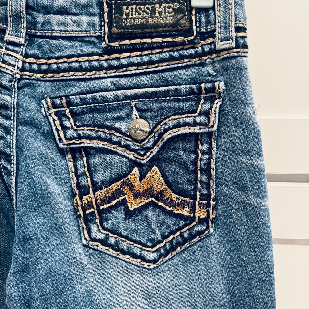 Miss Me Jeans with tan thread gold sequin design on pockets.